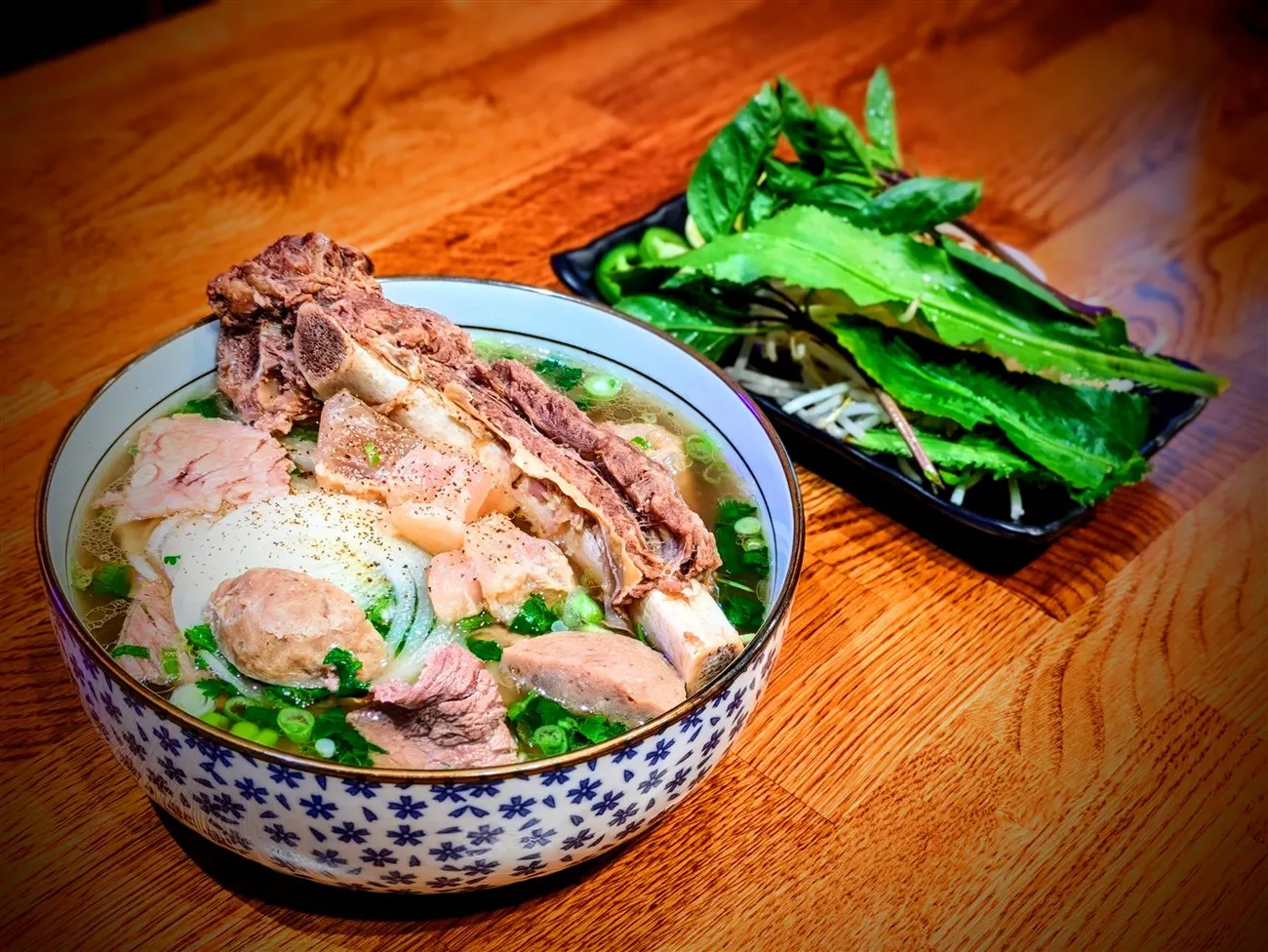 Bowl of The Fire Phở with brisket and filet in 22-hour beef bone broth at Fire Pho in Huntington Beach, CA.